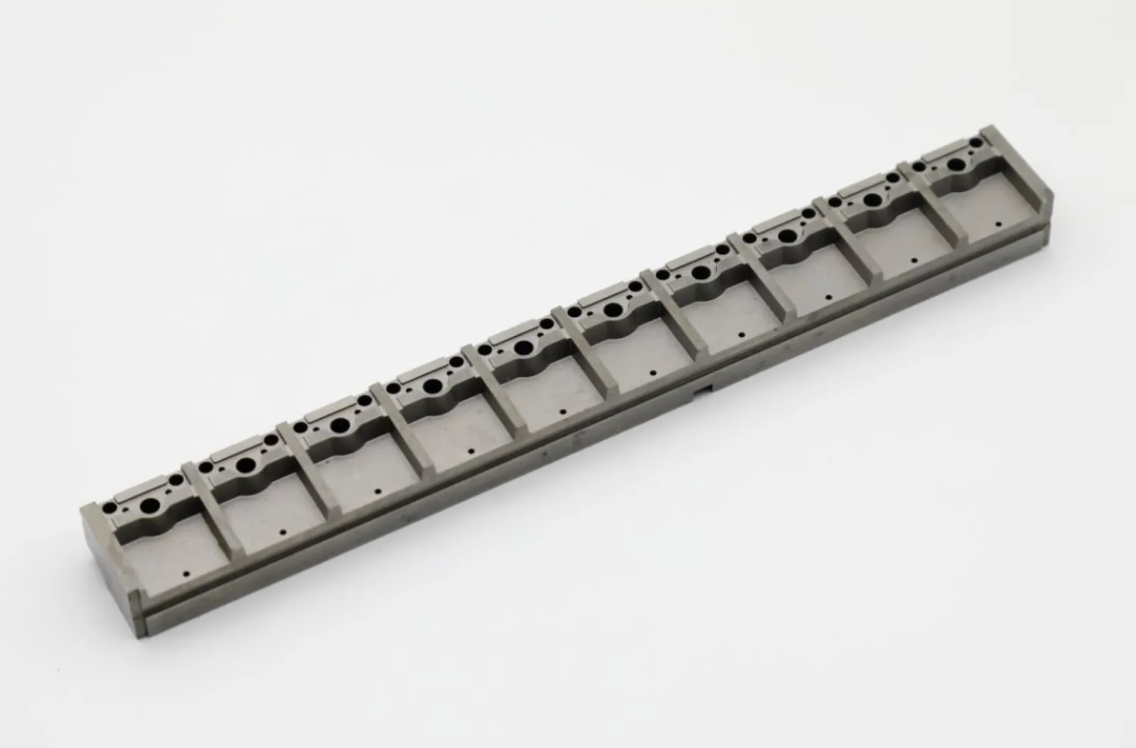 Precision mold component with machined holes and slots