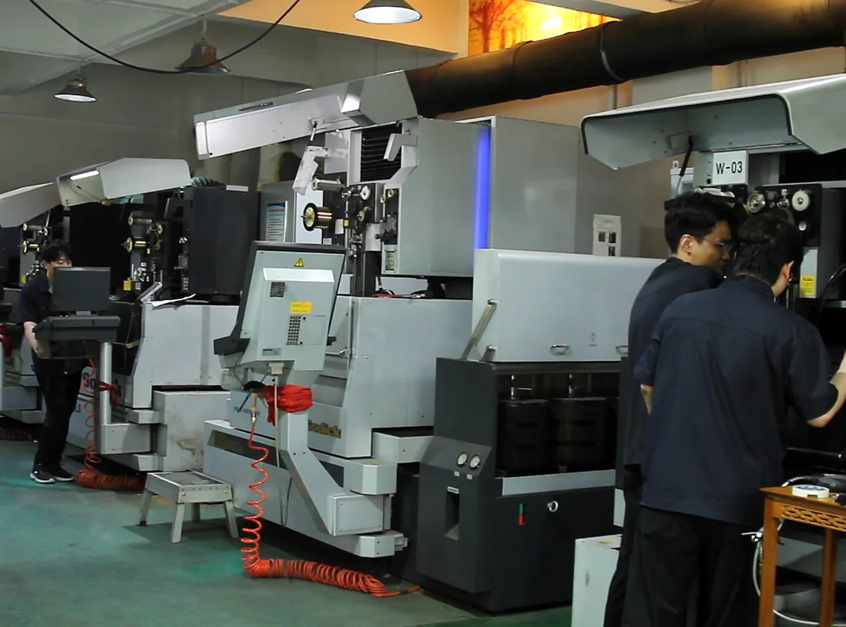 RIXIN technicians operating Wire EDM machines
